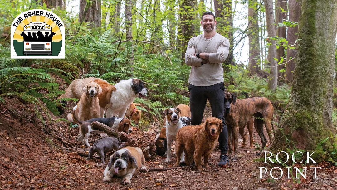 Lee Asher with dog pack in the woods